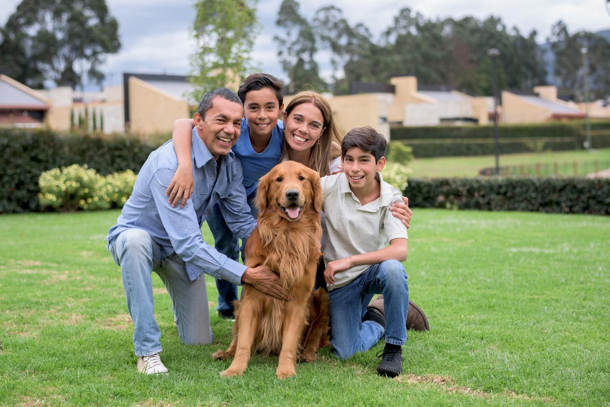 A happy smiling family with a dog.